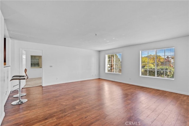 unfurnished living room with dark hardwood / wood-style floors