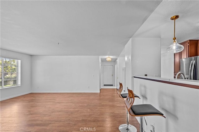 living room with light hardwood / wood-style floors and sink