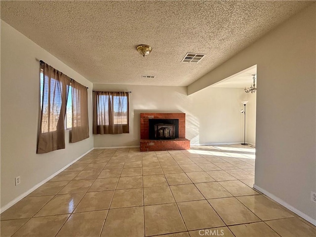 unfurnished living room featuring a textured ceiling, light tile patterned floors, beam ceiling, a notable chandelier, and a fireplace