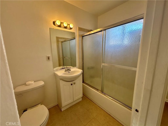 full bathroom featuring shower / bath combination with glass door, vanity, tile patterned flooring, and toilet