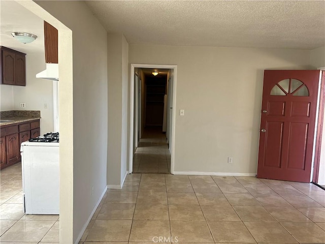 tiled foyer featuring a textured ceiling