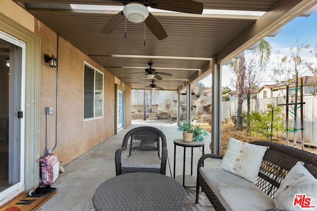 view of patio / terrace featuring ceiling fan and an outdoor living space