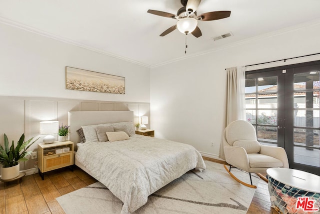 bedroom featuring wood-type flooring, french doors, ceiling fan, and crown molding