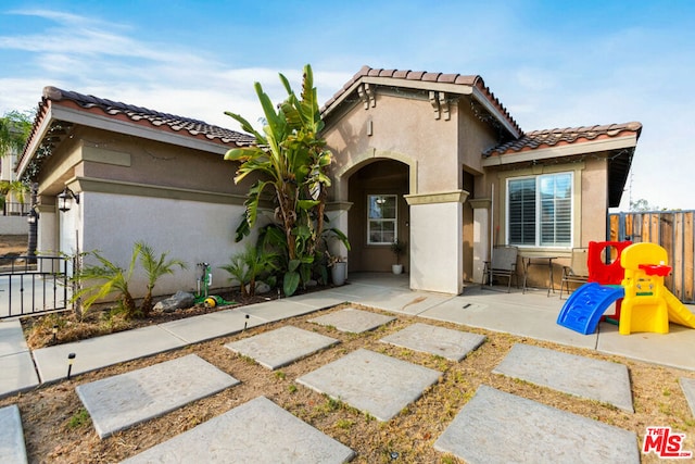 mediterranean / spanish-style home featuring a patio area