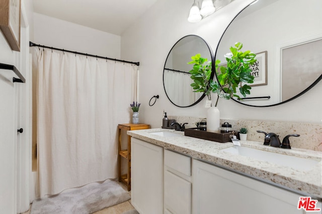 bathroom featuring vanity and shower / bath combo with shower curtain