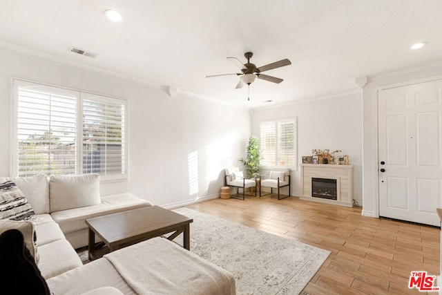 living room featuring ceiling fan, light wood-type flooring, and ornamental molding