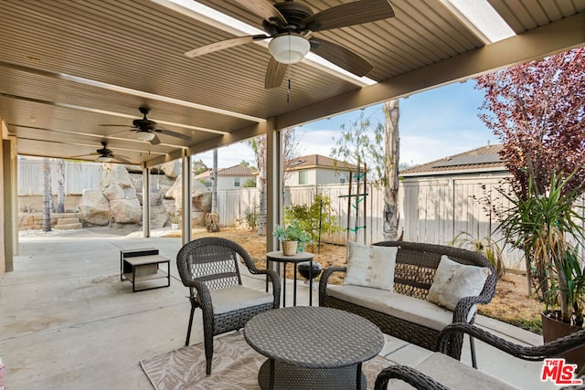 view of patio with ceiling fan and an outdoor living space