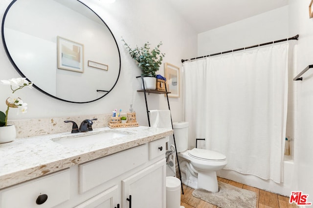 full bathroom with wood-type flooring, vanity, toilet, and shower / bath combination with curtain