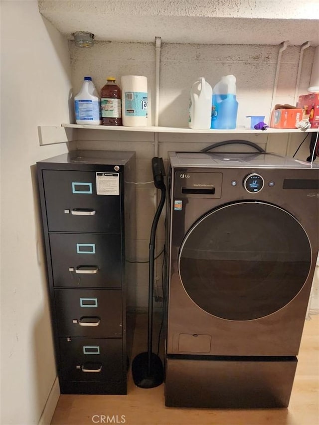 washroom featuring hardwood / wood-style flooring and washer and dryer