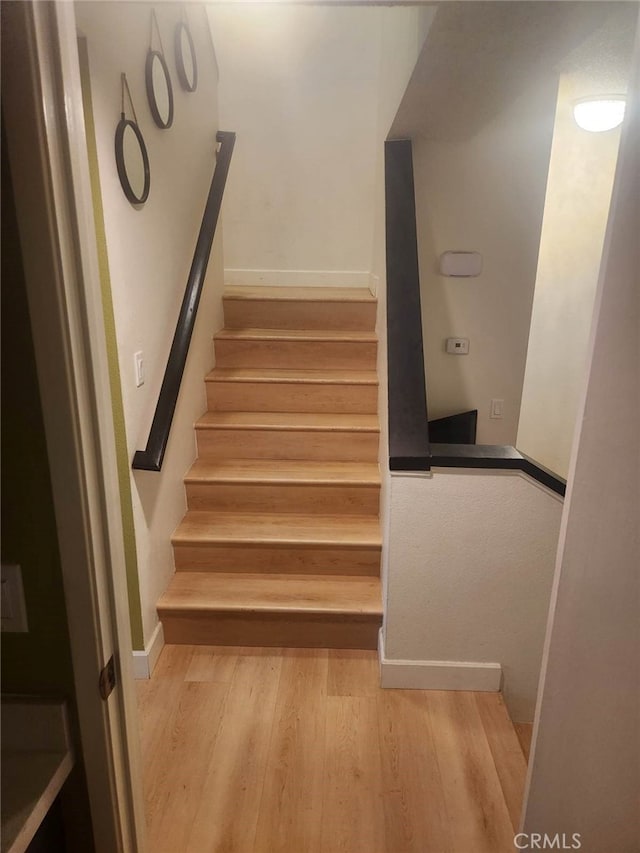 stairway with wood-type flooring