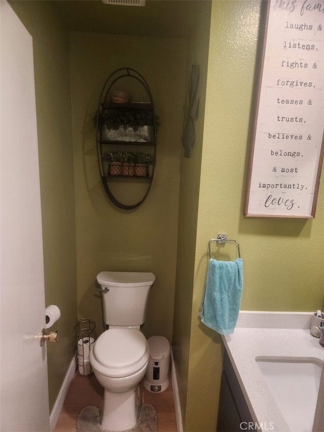 bathroom featuring tile patterned flooring, vanity, and toilet