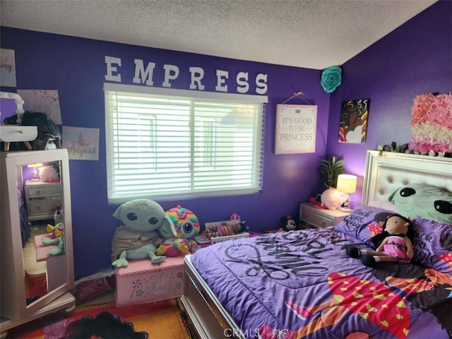 bedroom featuring multiple windows and a textured ceiling