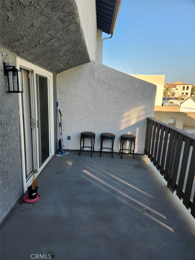 view of patio featuring a balcony