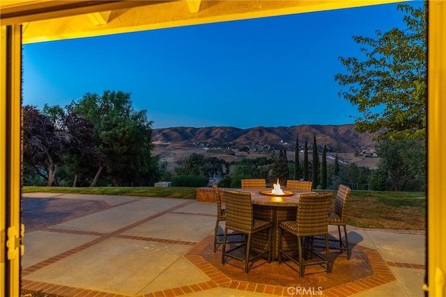 view of patio featuring a mountain view and an outdoor fire pit