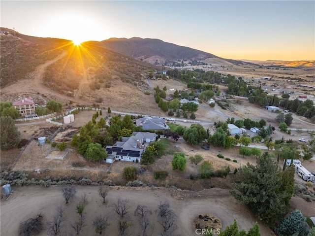 aerial view at dusk featuring a mountain view