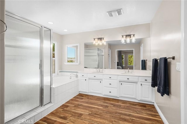 bathroom featuring vanity, wood-type flooring, and independent shower and bath