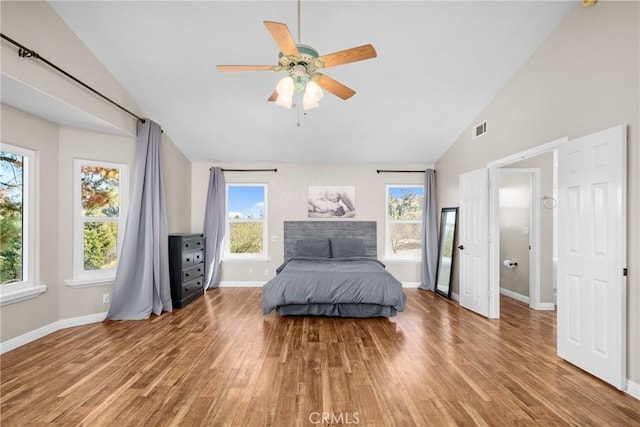 bedroom featuring multiple windows, ceiling fan, high vaulted ceiling, and wood-type flooring