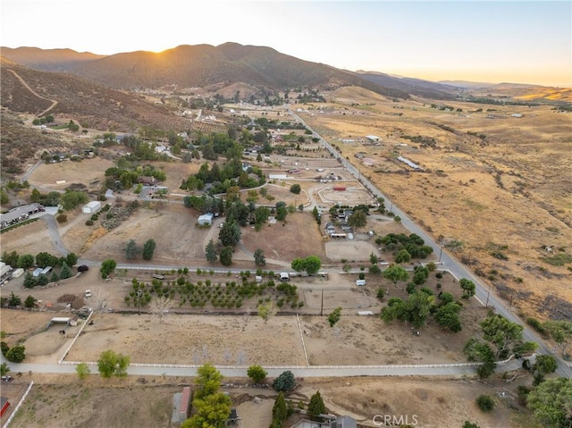 aerial view at dusk featuring a mountain view