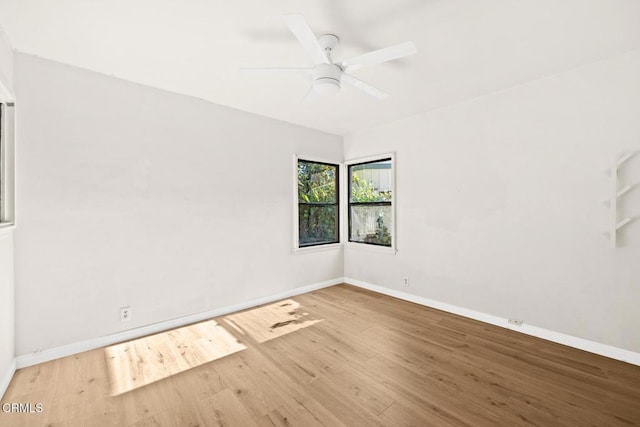 unfurnished room with ceiling fan and wood-type flooring