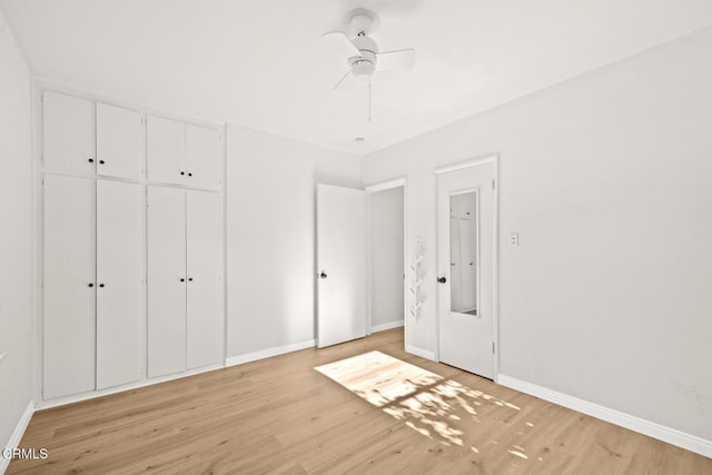 unfurnished bedroom featuring a closet, light hardwood / wood-style flooring, and ceiling fan