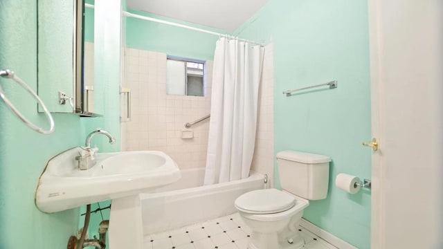 bathroom with toilet and shower / tub combo with curtain