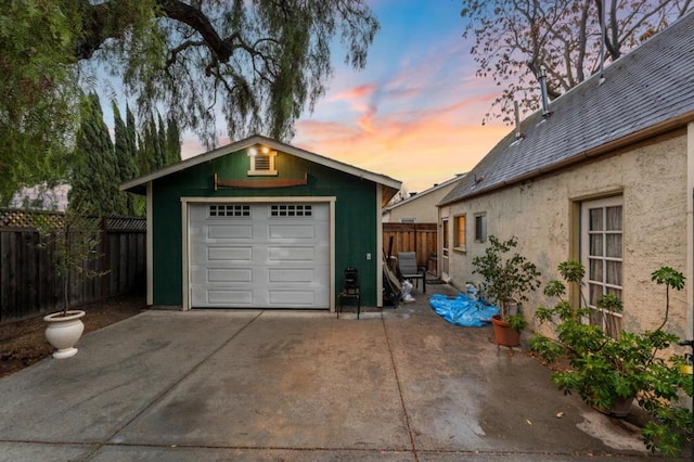 view of garage at dusk