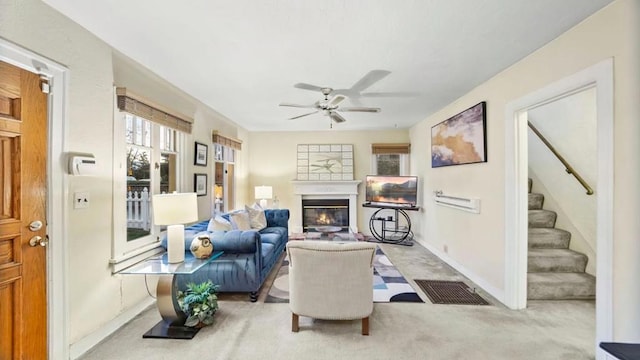 carpeted living room with ceiling fan