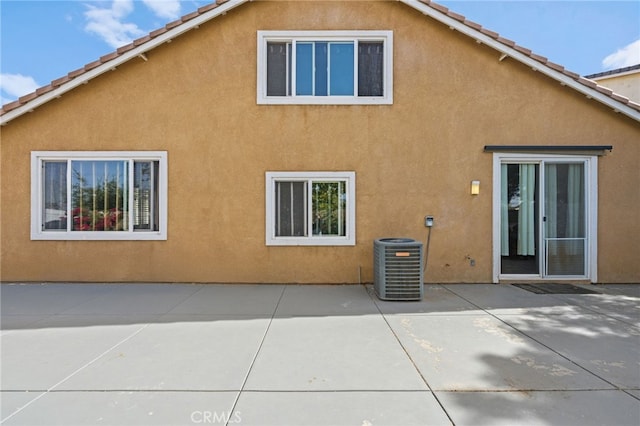 24809 Melrose Dr, Menifee, CA 92585 - back of house with stucco siding, cooling unit, a tiled roof, and a patio area