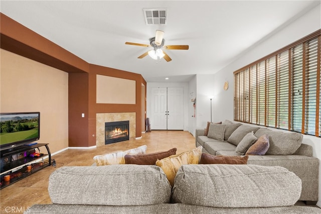 24809 Melrose Dr, Menifee, CA 92585 - living area with a fireplace, visible vents, ceiling fan, and baseboards