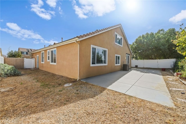 view of side of home featuring a patio and central AC