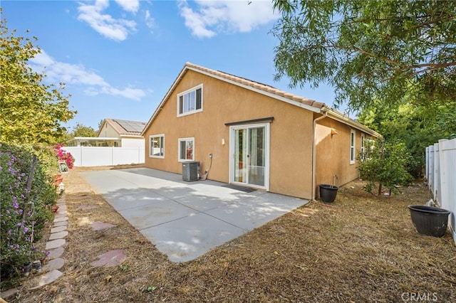 back of property featuring cooling unit and a patio area