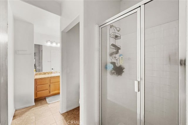 24809 Melrose Dr, Menifee, CA 92585 - bathroom featuring baseboards, a stall shower, tile patterned flooring, and vanity