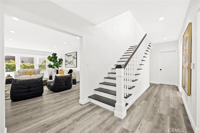 staircase featuring wood-type flooring