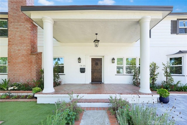 view of exterior entry with covered porch