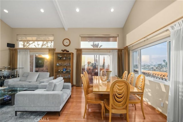 dining area featuring light hardwood / wood-style flooring and vaulted ceiling