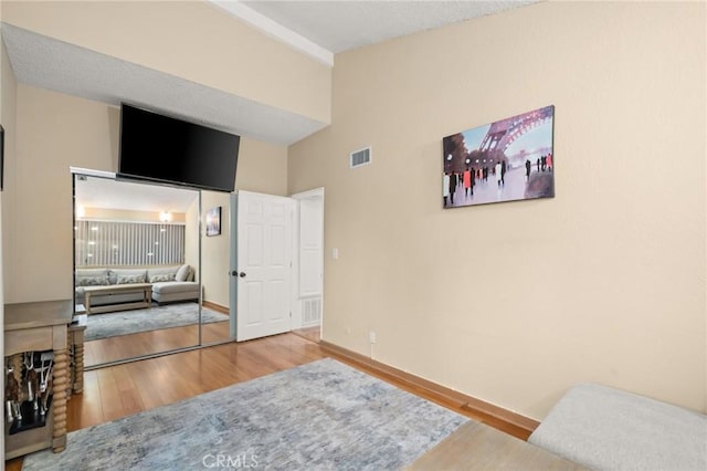 bedroom with wood-type flooring and a closet