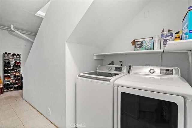 laundry room with washing machine and dryer and light tile patterned flooring