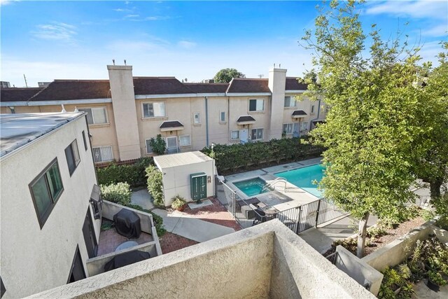 view of swimming pool with grilling area and an outdoor structure