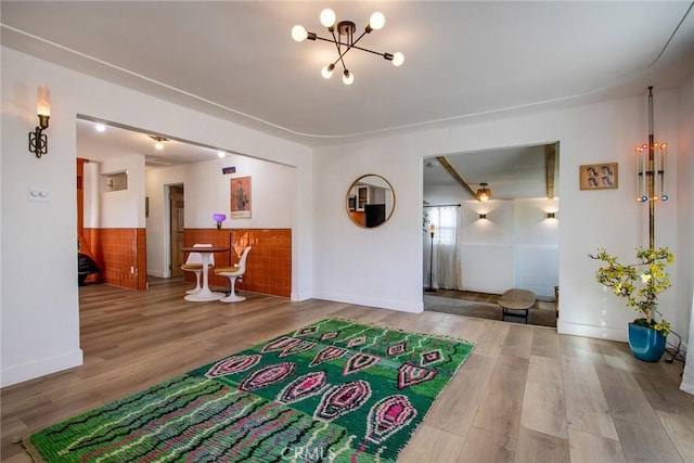 entryway with hardwood / wood-style floors and a chandelier