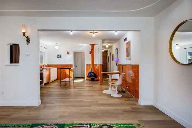 corridor featuring sink and light hardwood / wood-style flooring