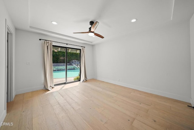 empty room featuring light hardwood / wood-style flooring and ceiling fan