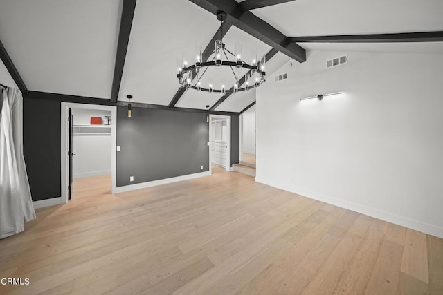 unfurnished living room featuring vaulted ceiling with beams, light wood-type flooring, and an inviting chandelier