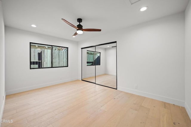 unfurnished bedroom with ceiling fan, a closet, and light hardwood / wood-style flooring