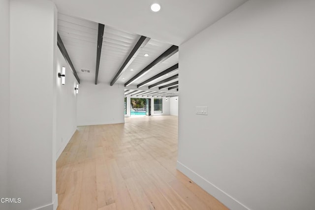 hallway with beamed ceiling and light hardwood / wood-style flooring