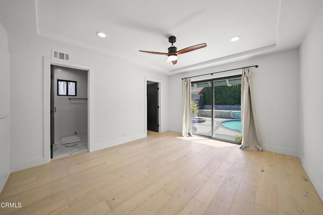 empty room featuring ceiling fan and light wood-type flooring