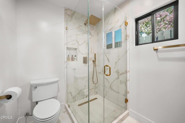 bathroom featuring tile patterned floors, toilet, and a shower with door