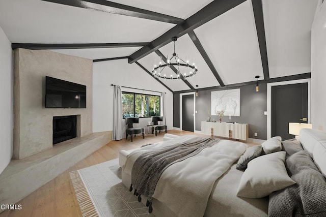 bedroom featuring radiator, a premium fireplace, light hardwood / wood-style flooring, lofted ceiling with beams, and a notable chandelier