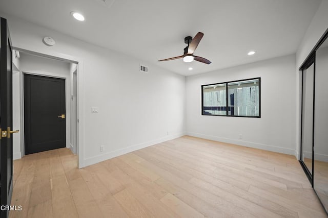 unfurnished bedroom featuring a closet, ceiling fan, and light hardwood / wood-style flooring