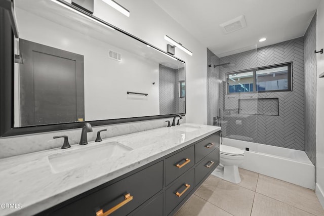 full bathroom featuring tile patterned flooring, vanity, toilet, and tiled shower / bath combo