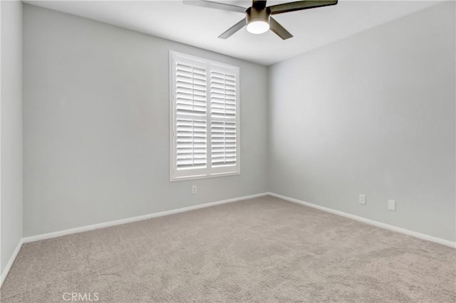 empty room featuring ceiling fan and light carpet